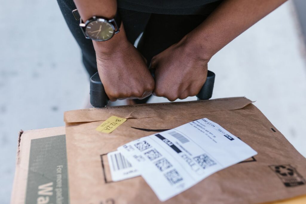 about-us Close-up of delivery worker handling a package with care outdoors.